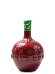Red cherry wine bottle with a green cap on a white background